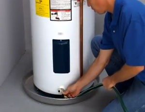 Technician repairing an electric water heater