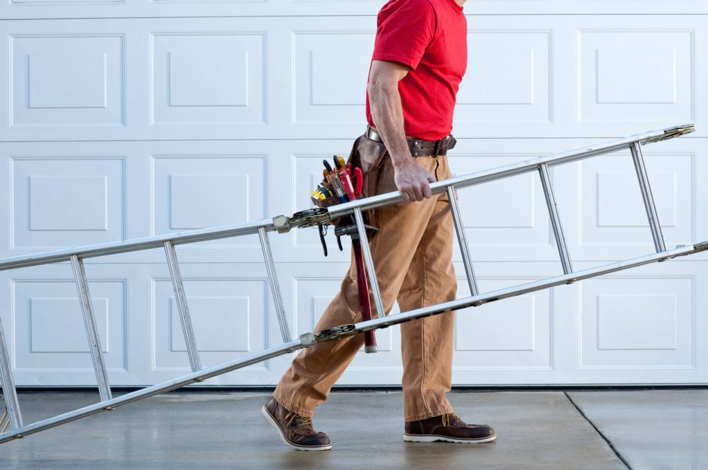Man carrying a ladder for home service