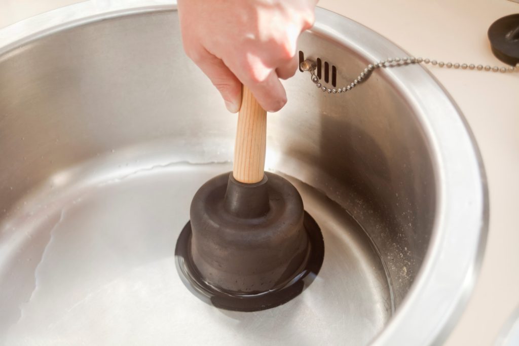 Plungers stored in a kitchen utensil holder