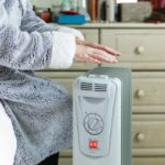 Portable space heater placed safely away from furniture and curtains, showing proper heater safety practices indoors