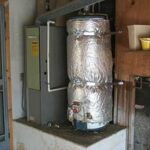 Insulating a home water heater with an insulation blanket to prevent heat loss during winter