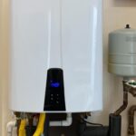Tankless water heater turned on displaying digital temperature and performance readings